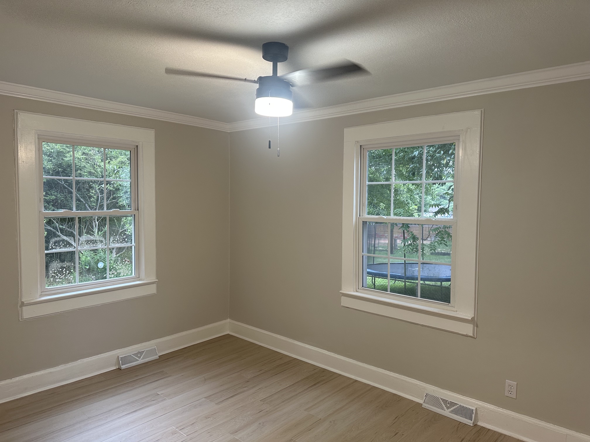 Bedroom with ceiling fan and crown moulding