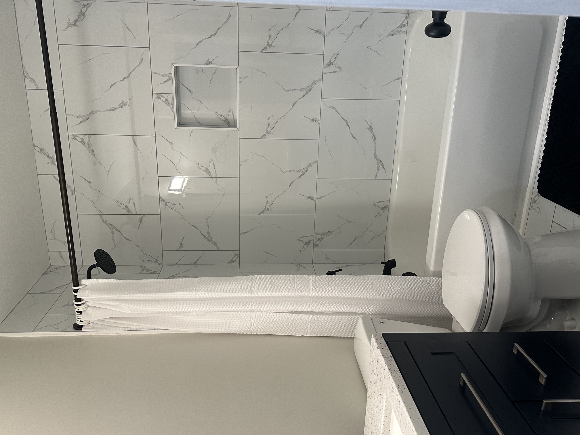 Renovated bathroom with tiled tub and shower