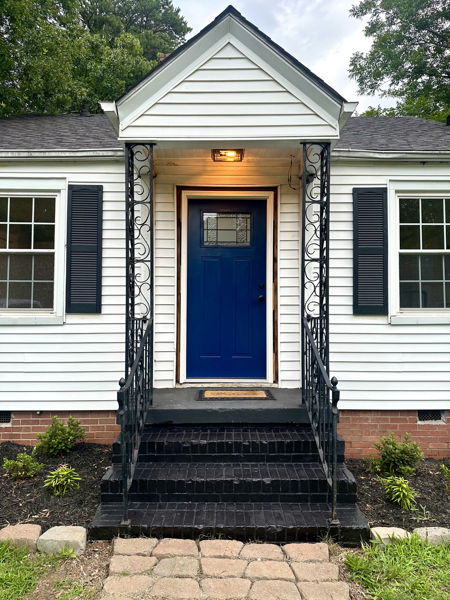 Covered front entrance with blue door